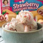 little debbie strawberry shortcake rolls ice cream in a gray bowl in front of a box of shortcake rolls