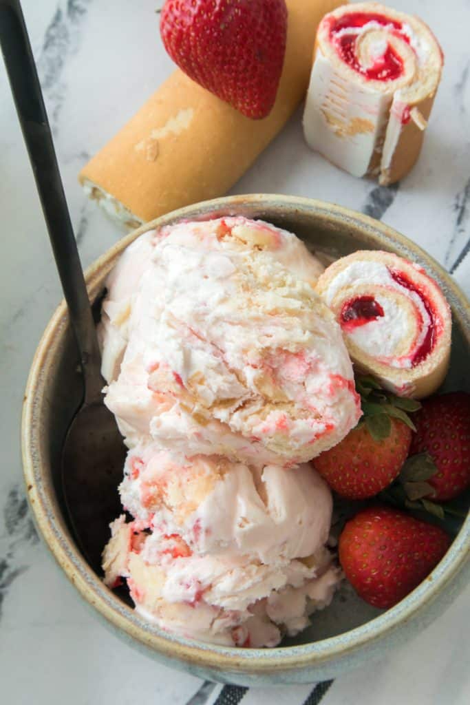 Copycat Little Debbie Strawberry shortcake ice cream in a gray bowl with a black spoon