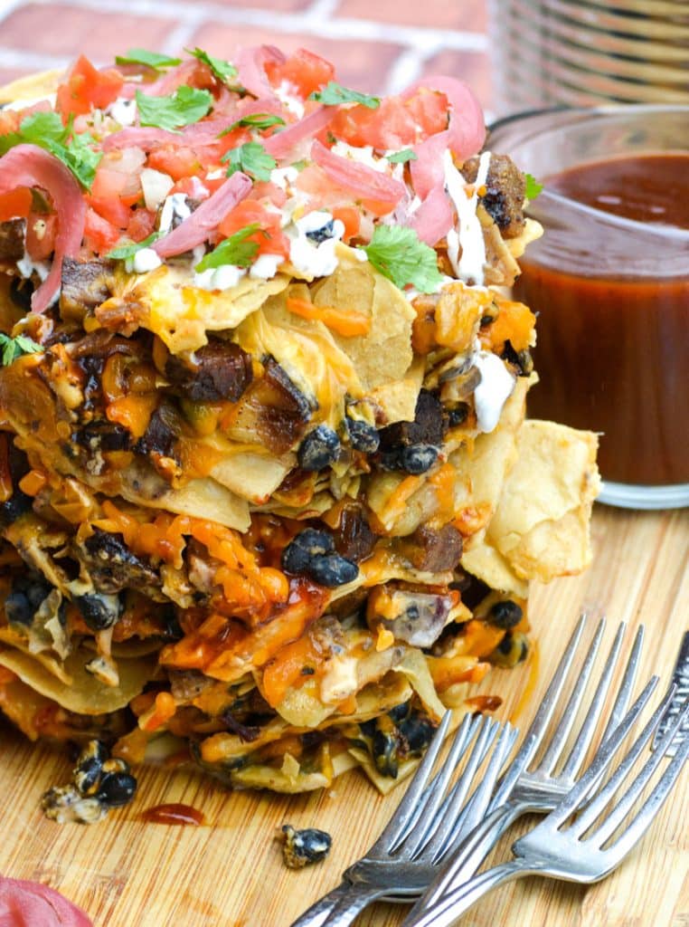 trash can nachos on a wooden cutting board