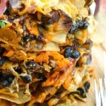 stacked trash can nachos on a wooden cutting board