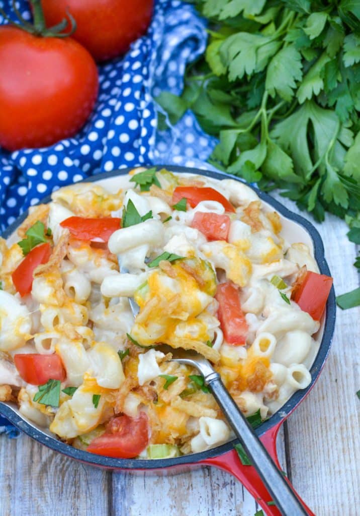 a fork digging into a small skillet filled with tuna melt mac & cheese