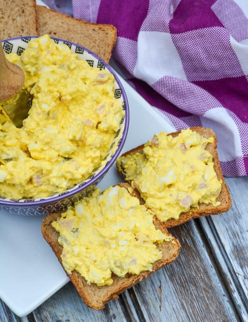 ham and egg salad spread on two pieces of party toast