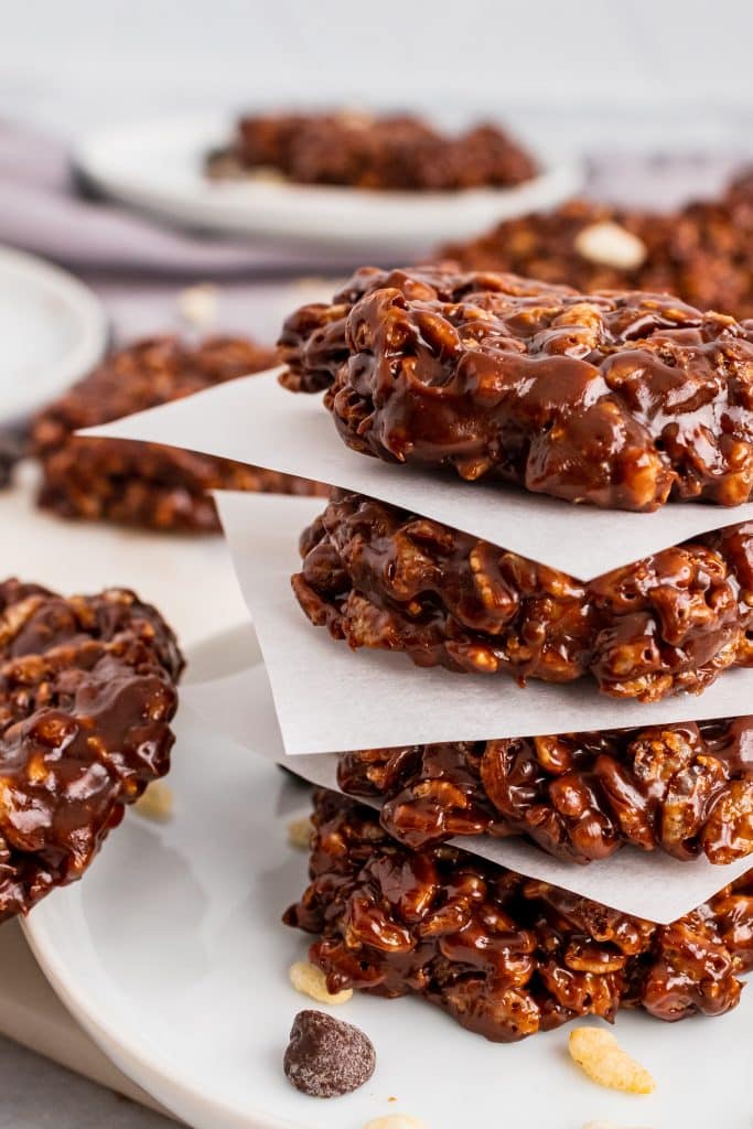 a stack of homemade star crunch cookies on small squares of white parchment paper