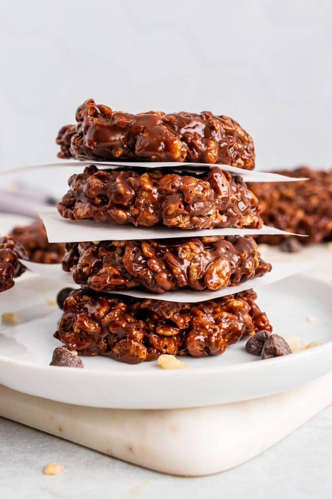 a stack of homemade star crunch cookies on small squares of white parchment paper