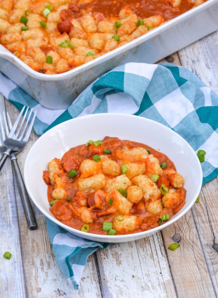 chili cheese dog tater tot casserole on a white bowl