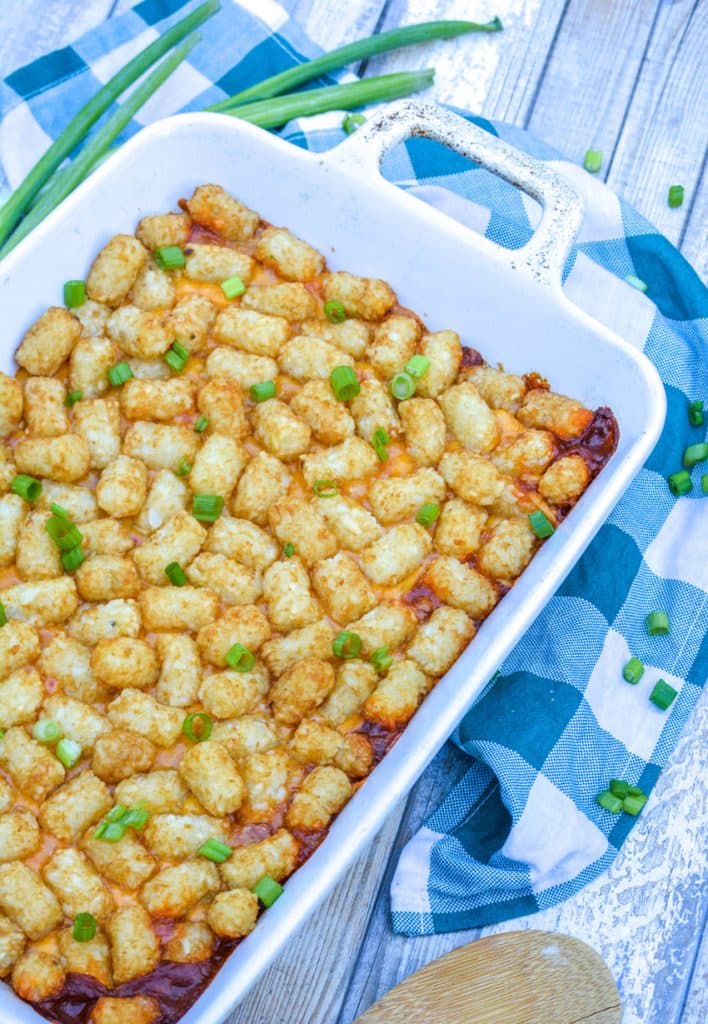 chili cheese dog tater tot casserole in a white casserole dish