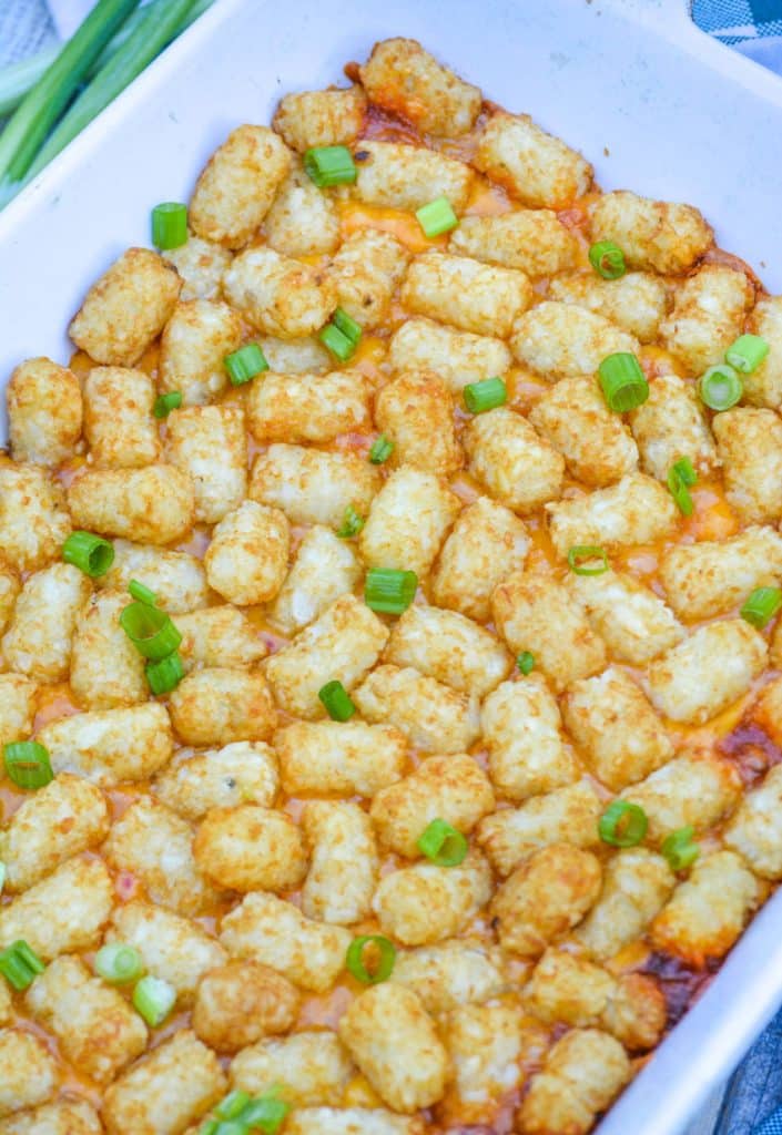 chili cheese dog tater tot casserole in a white casserole dish