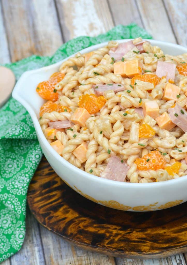 macaroni salad with ham and pineapple in a white serving bowl