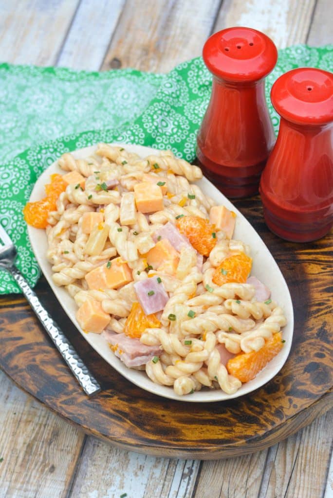 hawaiian pasta salad in a small bowl on a wooden serving platter