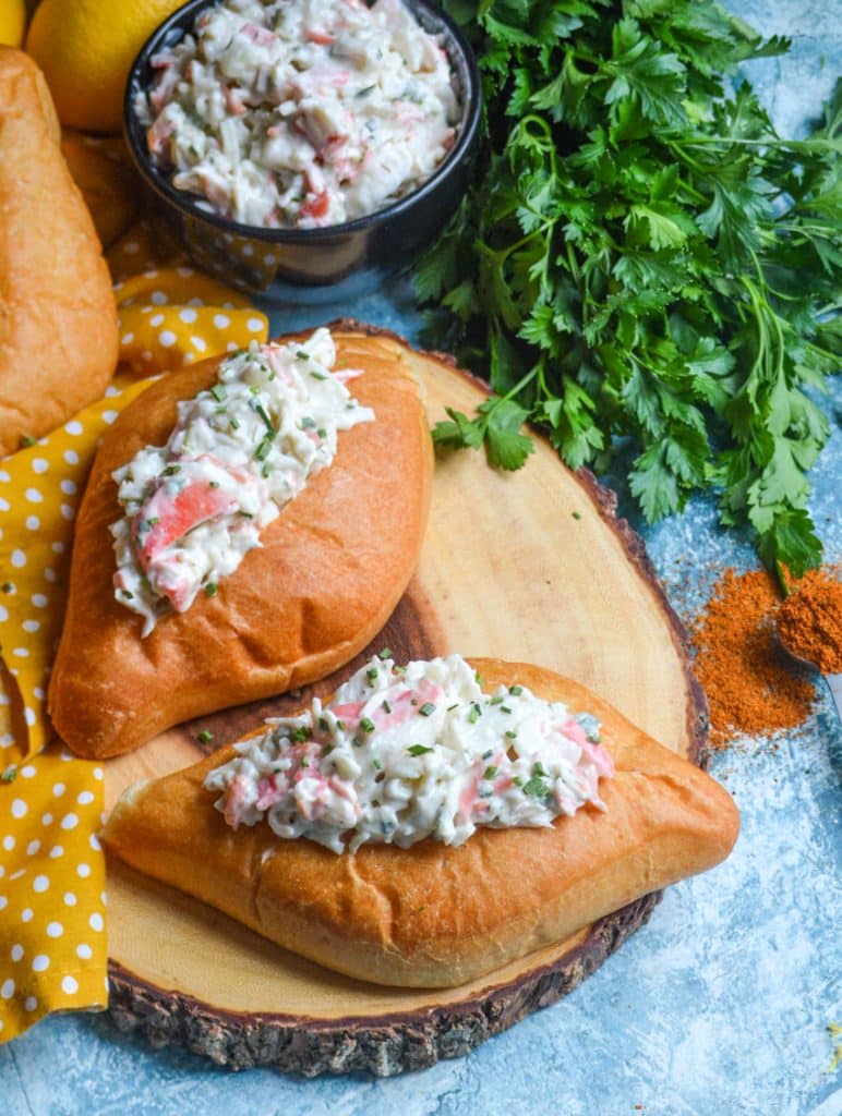 easy seafood salad served on bolillo rolls on a wooden cutting board
