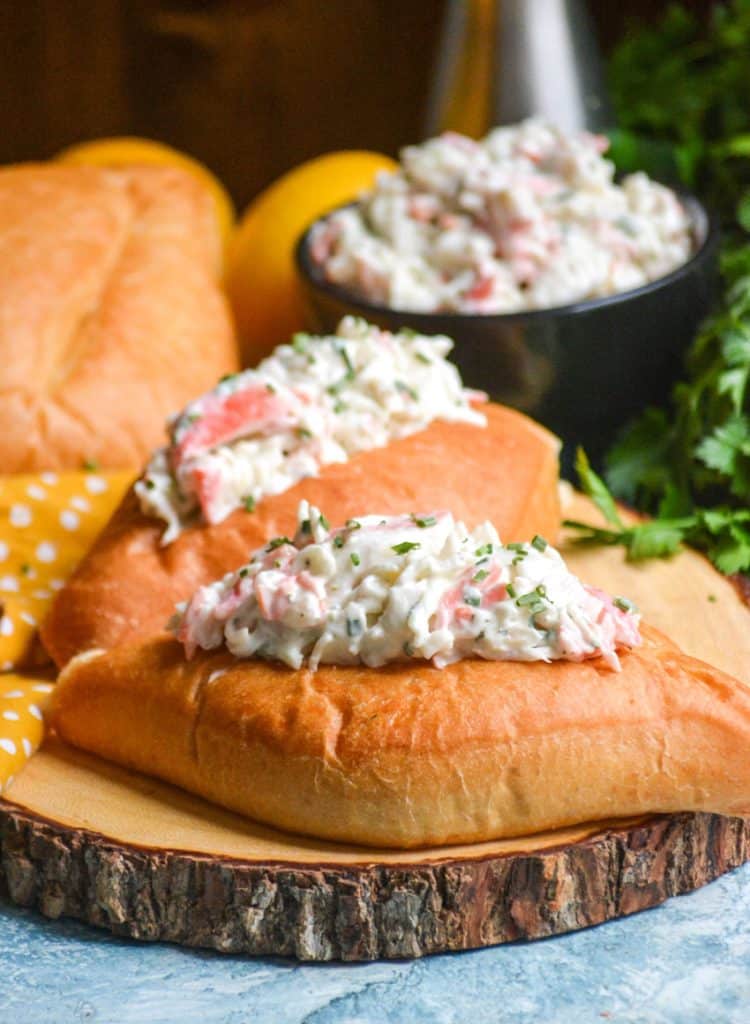 easy seafood salad served on bolillo rolls on a wooden cutting board