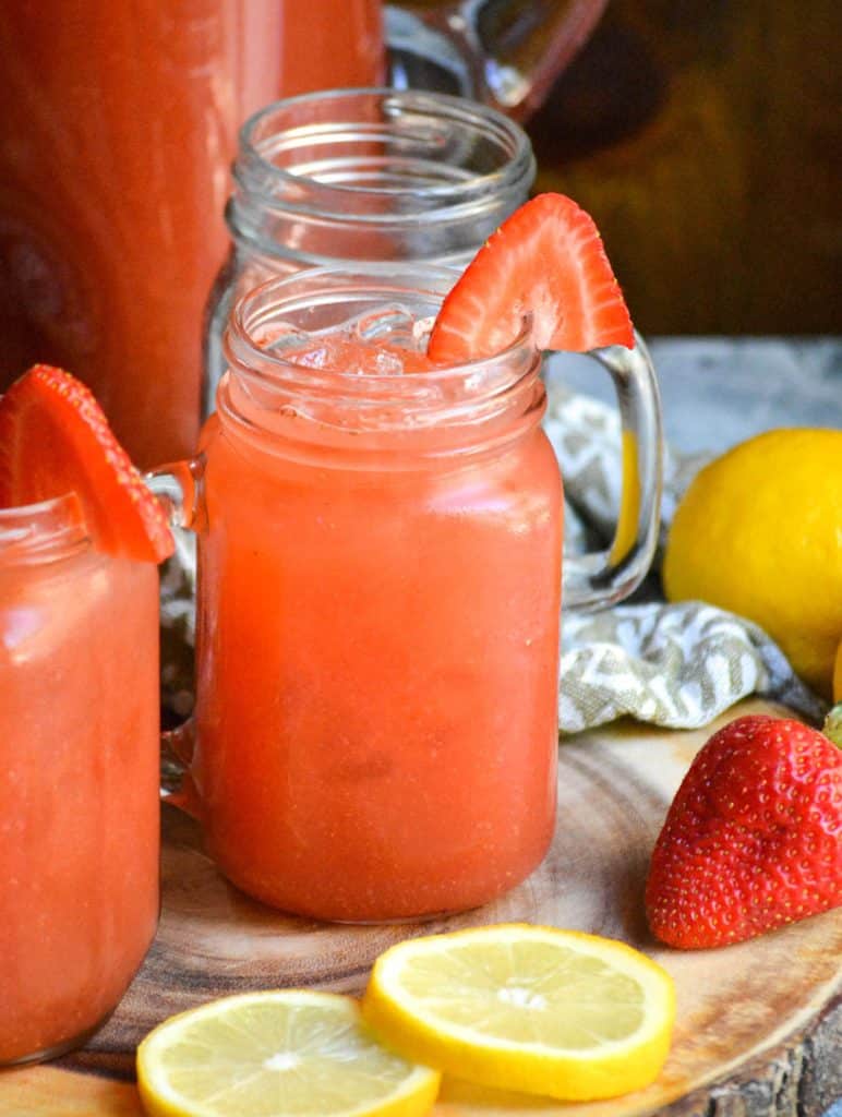 ice filled glasses of easy strawberry lemonade garnished with a fresh strawberry slice
