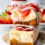 Philadelphia strawberry cheesecake snack bars stacked on top of each other on a small white snack plate