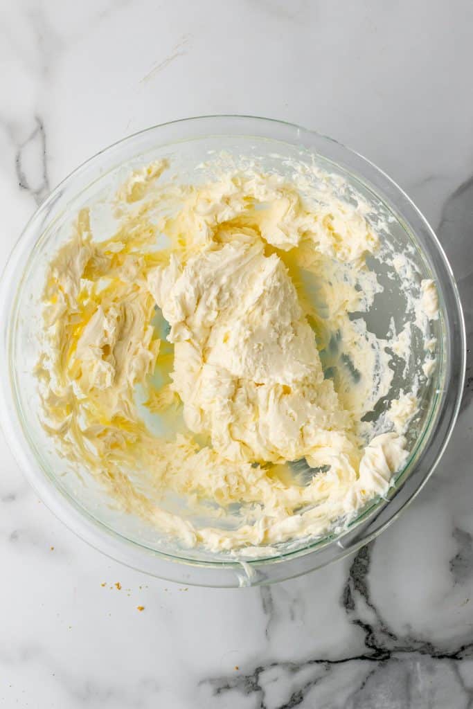 whipped cream cheese in a glass mixing bowl