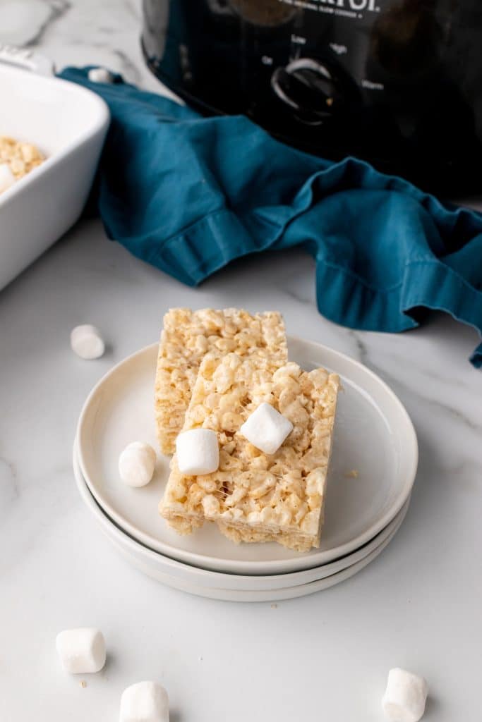 two crockpot rice krispie treats stacked together on a small white plate
