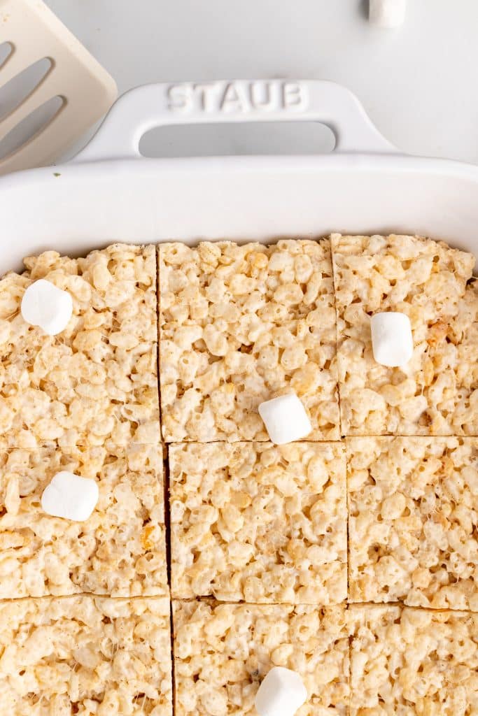 slow cooker rice krispie treats spread in a white casserole dish