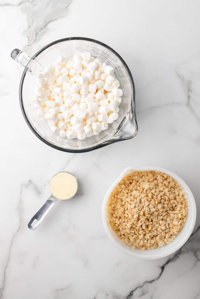 overhead image showing the measured ingredients needed for a batch of slow cooker rice krispies treats