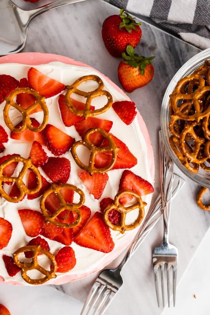 strawberry pretzel pie on a marble cutting board
