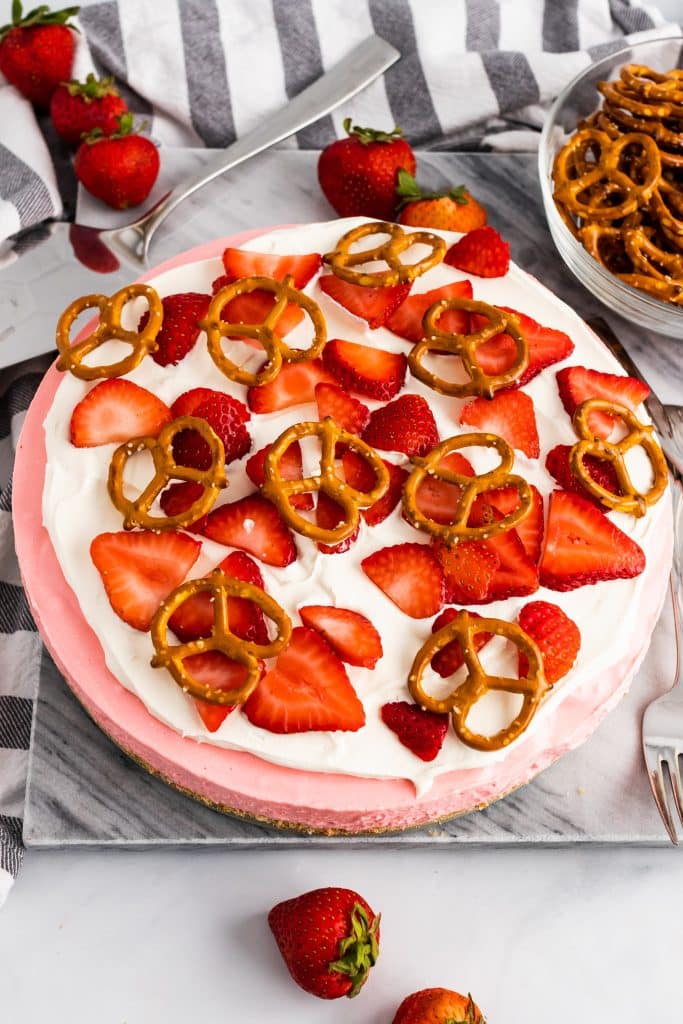 strawberry pretzel pie on a marble cutting board