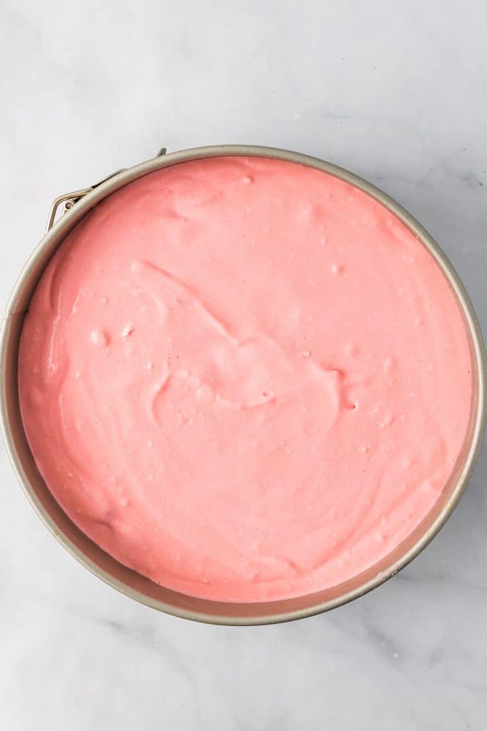 strawberry pretzel pie filling in a springform pan