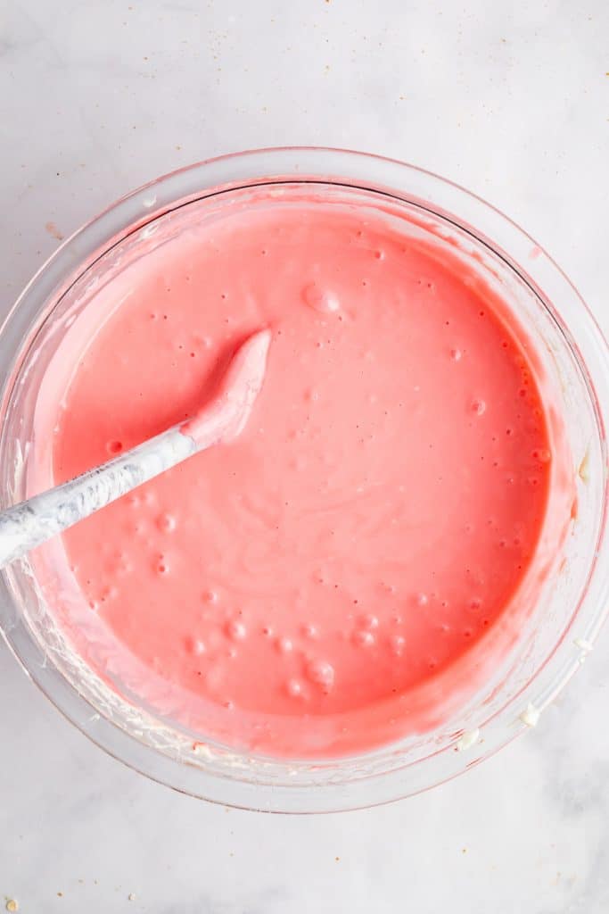 pink creamy strawberry pie filling in a glass mixing bowl