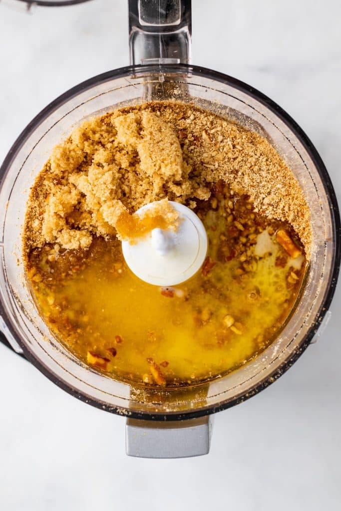 crushed pretzels and melted butter in the bowl of a food processor