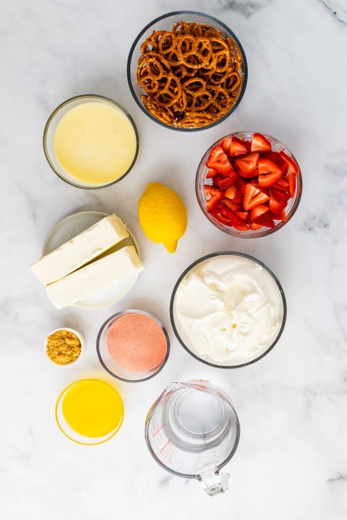 overhead image showing the measured ingredients needed to make a strawberry pretzel salad pie