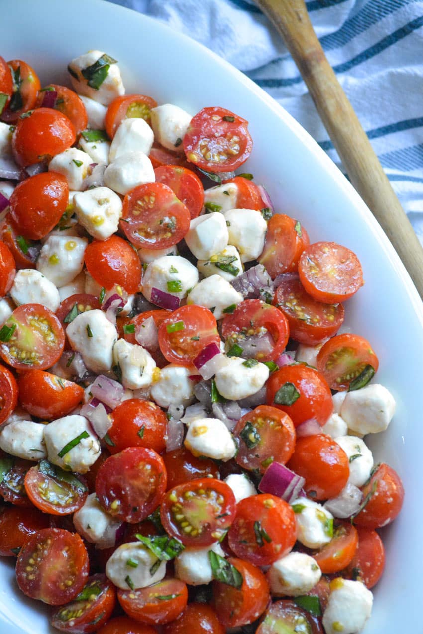 sweet cherry tomato salad in a shallow white oval bowl