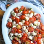 sweet cherry tomato salad in a shallow white oval bowl