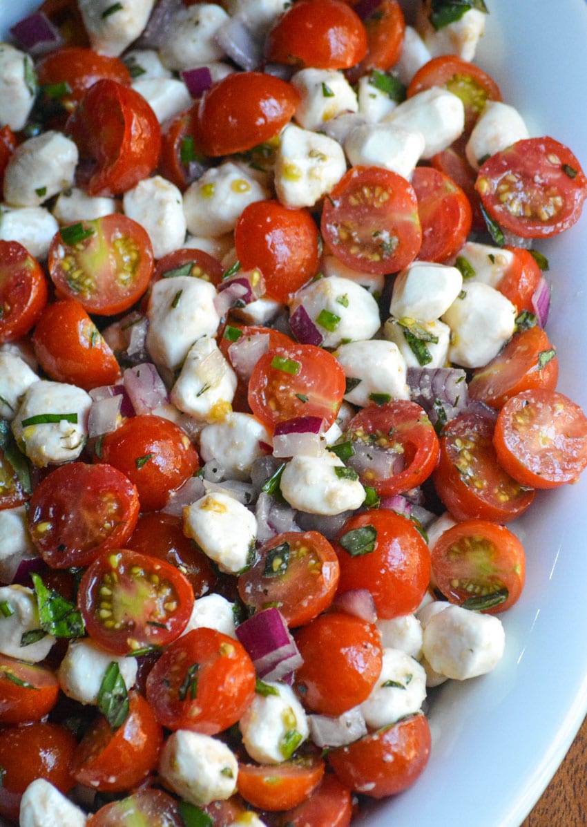 sweet cherry tomato salad in a shallow white oval bowl