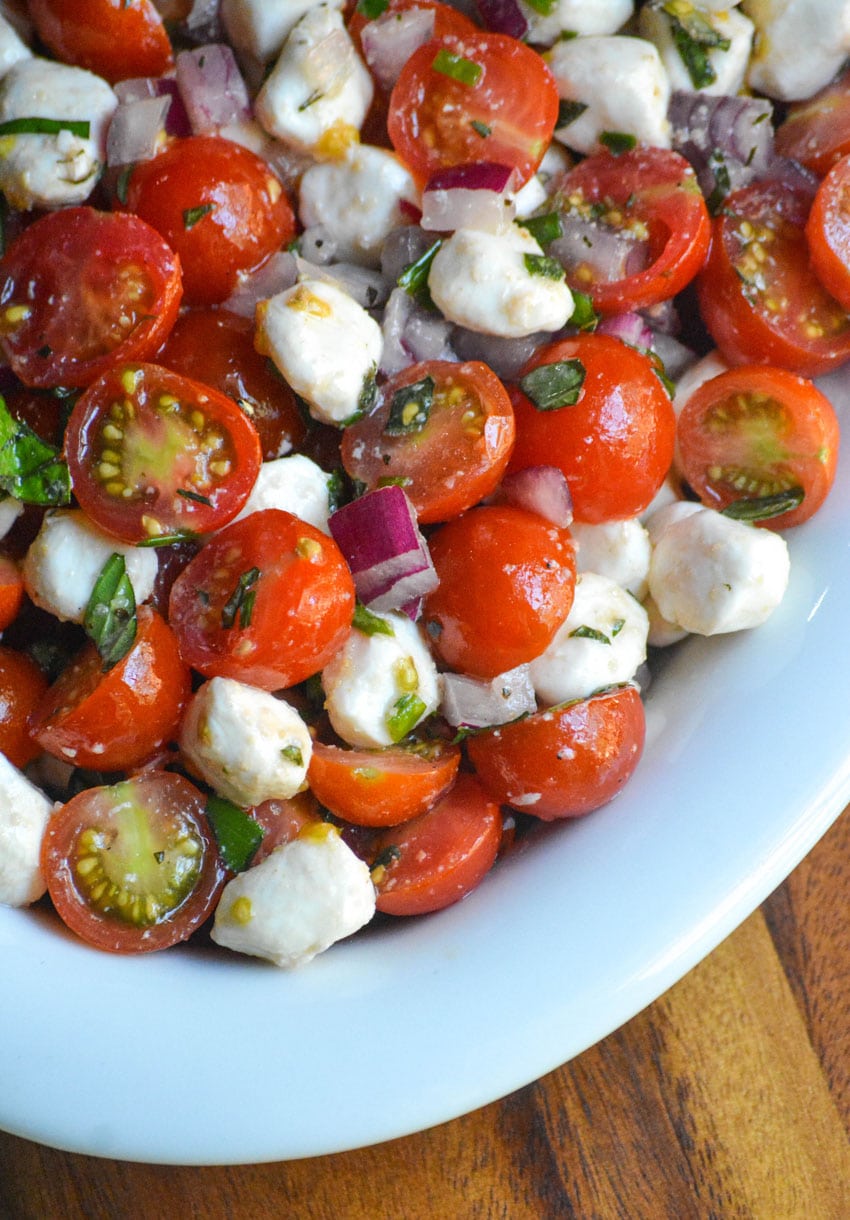 sweet cherry tomato salad in a shallow white oval bowl