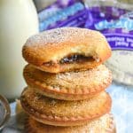 a stack of four fried uncrustables in front of a jar of milk