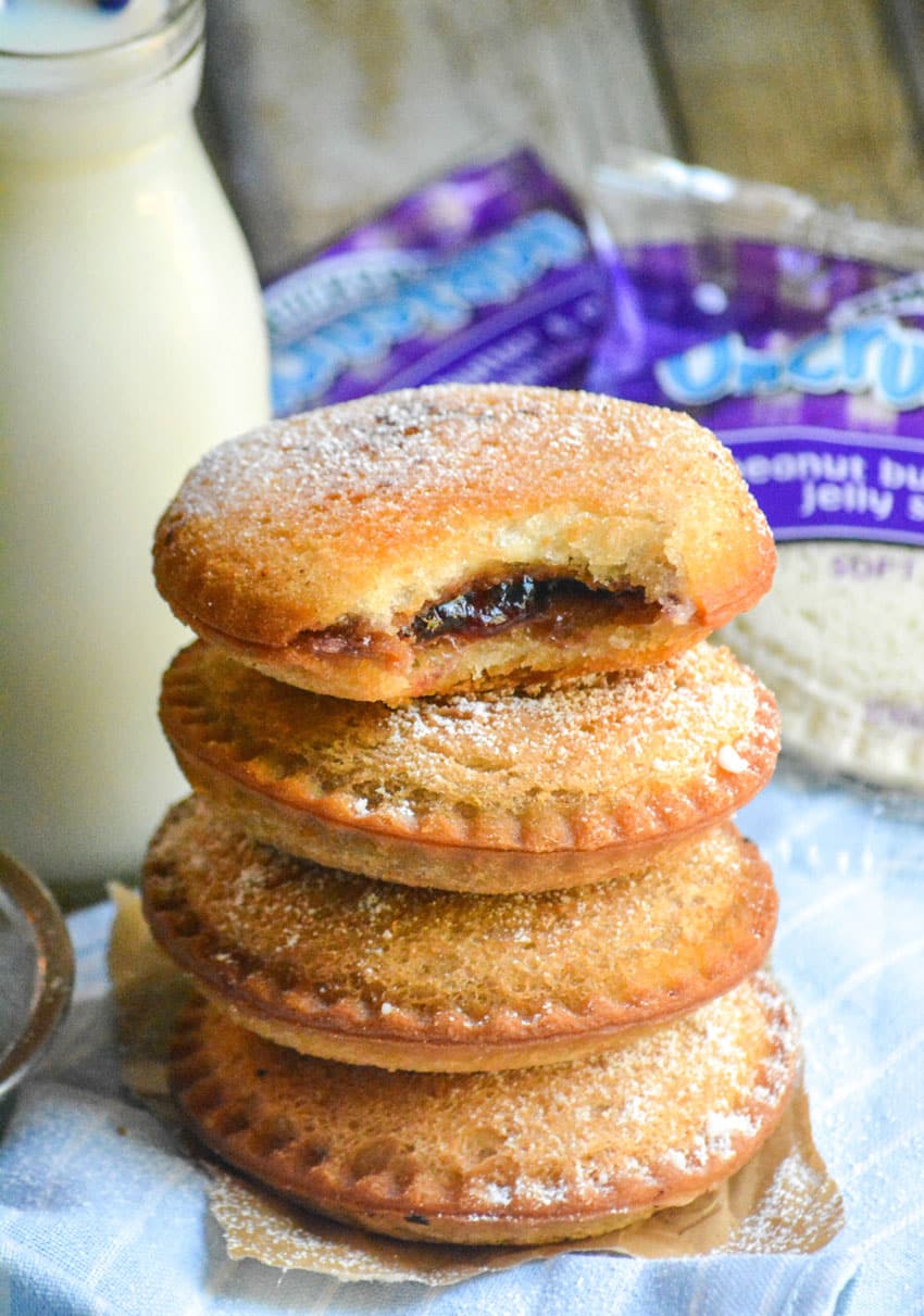 a stack of four fried uncrustables in front of a jar of milk