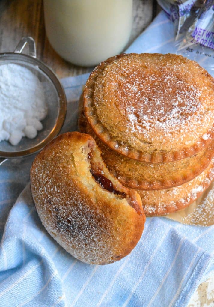 a stack of four fried uncrustables in front of a jar of milk