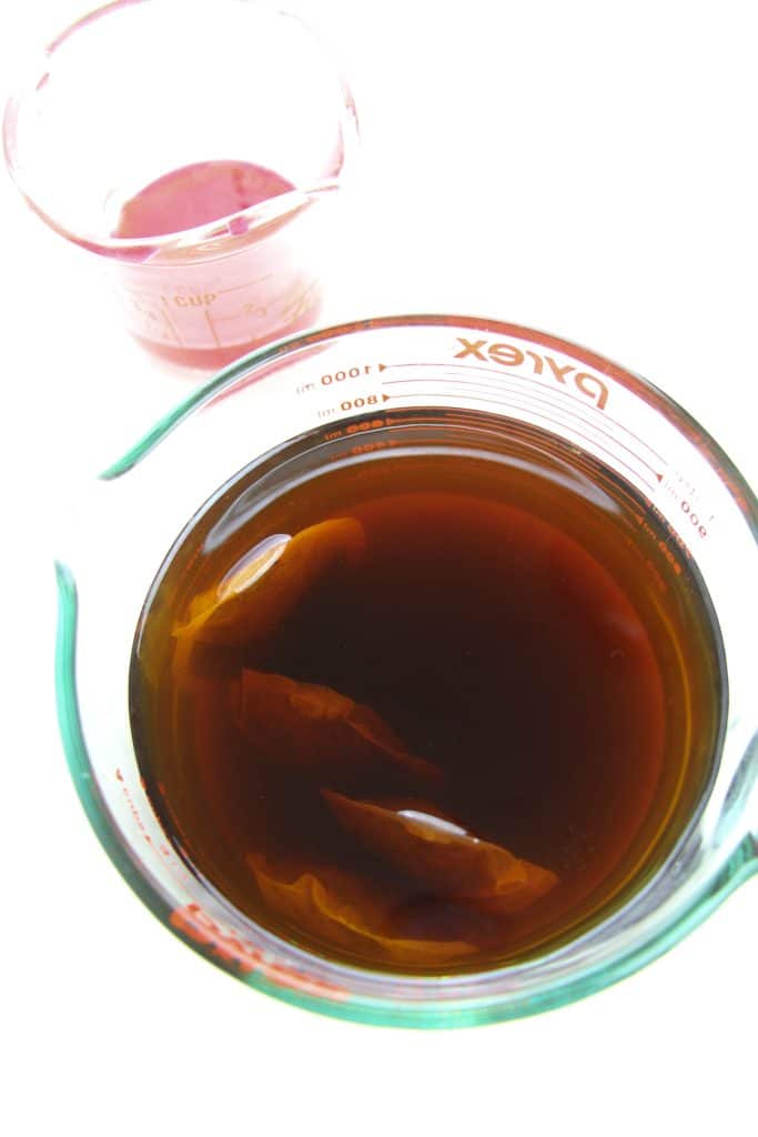 tea bags steeping in a glass measuring bowl
