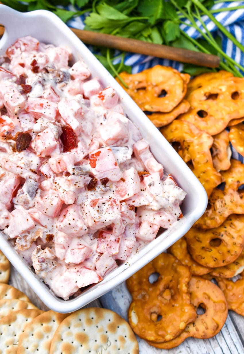 creamy tomato bacon dip in a white dish