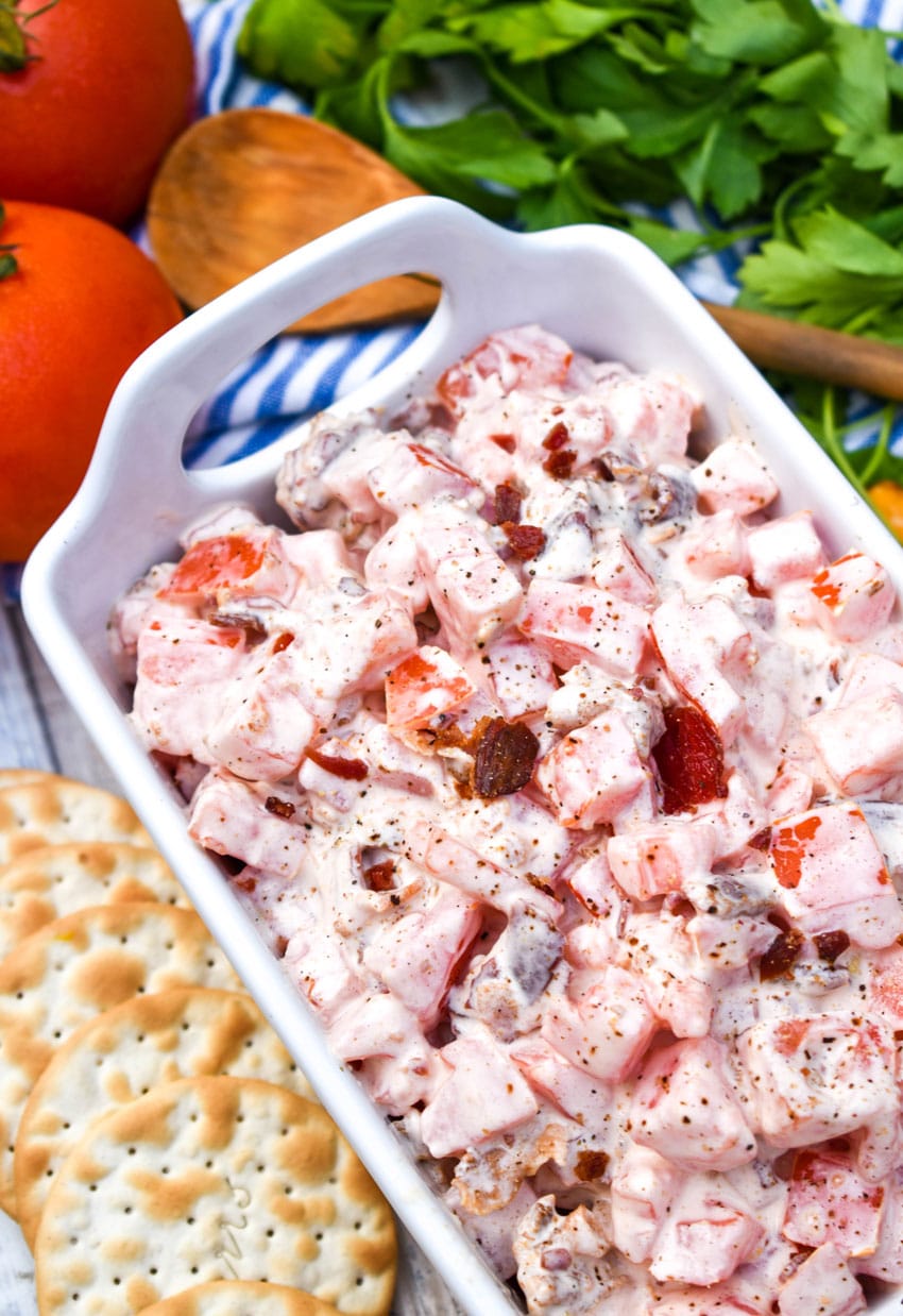 creamy tomato bacon dip in a white dish