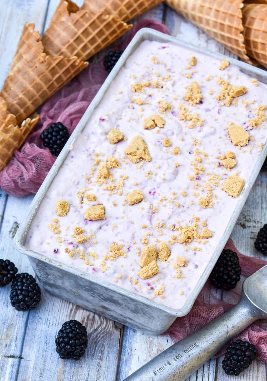 blackberry cheesecake ice cream in a metal loaf pan topped with graham cracker pieces