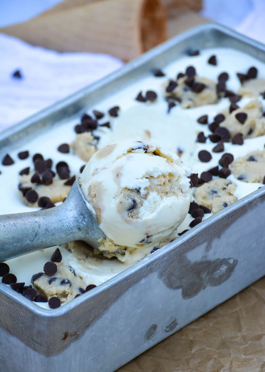 No Churn Cookie Dough Ice Cream a silver ice cream scoop with a ball of no churn cookie dough ice cream in a metal loaf pan
