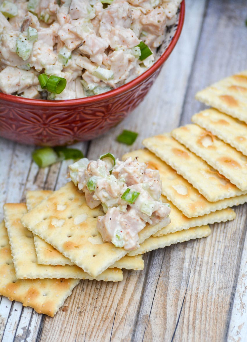 Southern style chicken salad spread on a saltine crackers