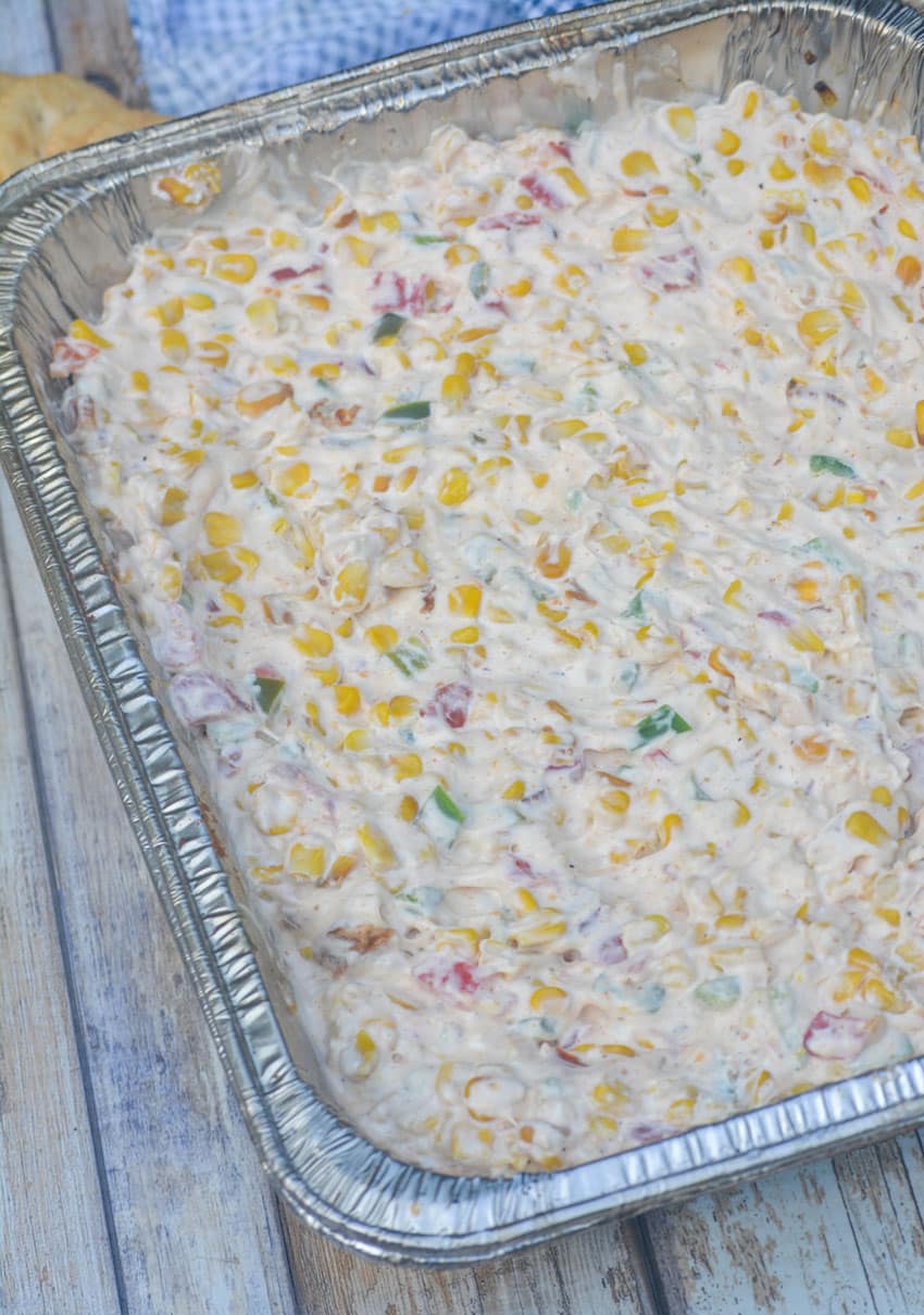 smoked cream corn dip in a disposable aluminum pan