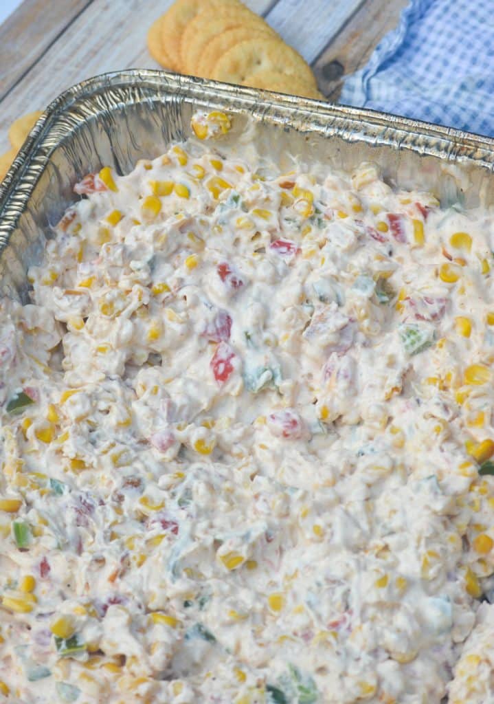 smoked creamy corn dip in a disposable aluminum pan