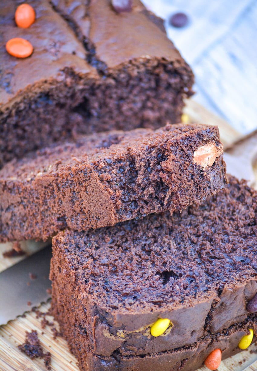 chocolate zucchini bread sliced on a wooden cutting board