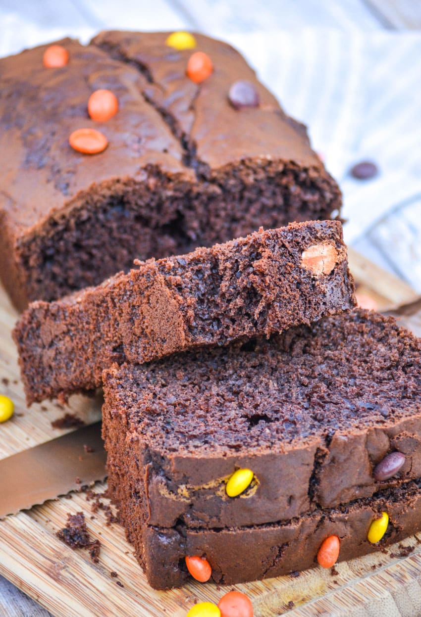 chocolate zucchini bread sliced on a wooden cutting board