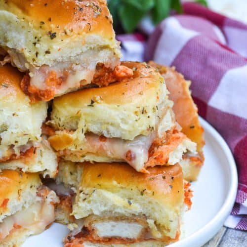 a stack of chicken nugget parmesan sliders on a white plate