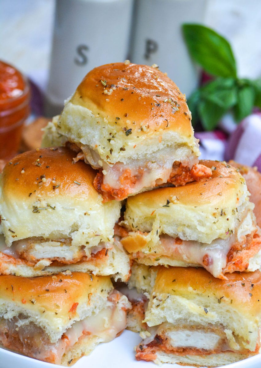 a stack of chicken nugget parmesan sliders on a white plate