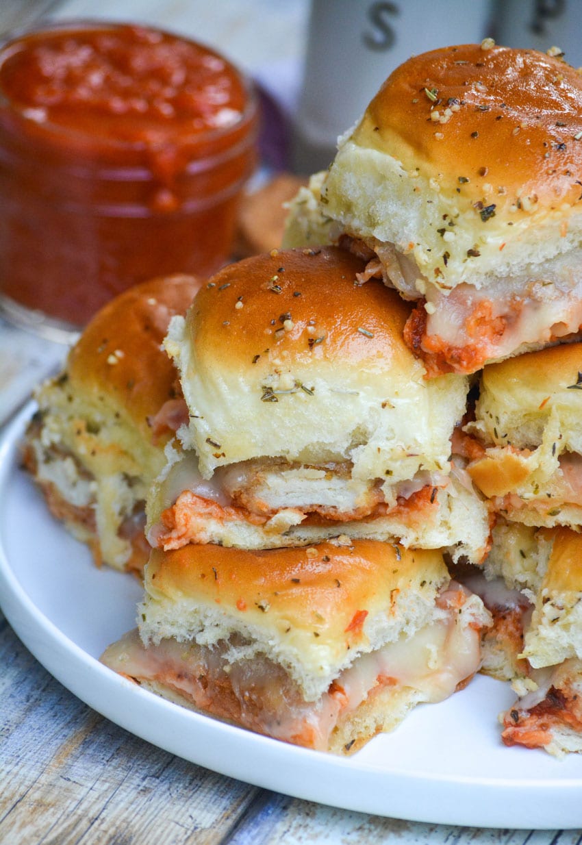 a stack of chicken nugget parmesan sliders on a white plate