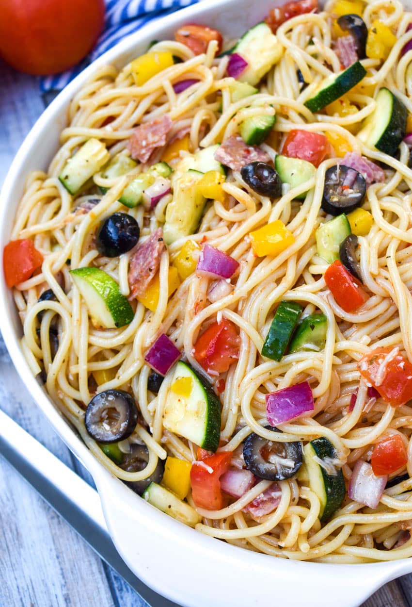 cold spaghetti salad in a white serving bowl