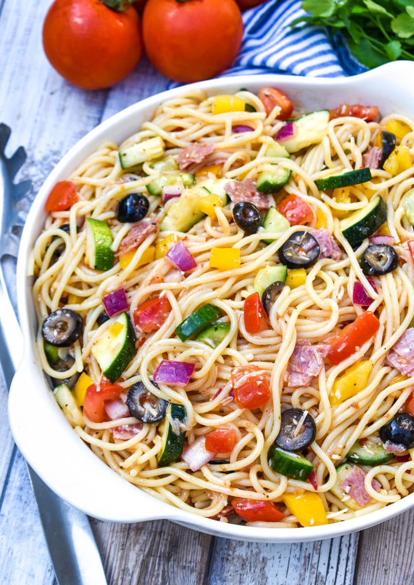 cold spaghetti salad in a white serving bowl