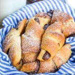 nutella crescent rolls sprinkled with powdered sugar in a cloth napkin lined basket